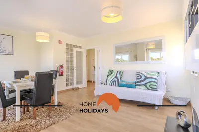 a living room with a table and a bedroom with a bed at #320 Quinta da Correeira 55 by Home Holidays in Vale de Pedras
