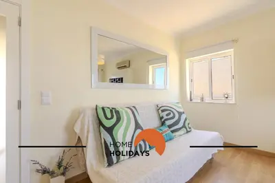 a living room with a couch and a mirror at #320 Quinta da Correeira 55 by Home Holidays in Vale de Pedras