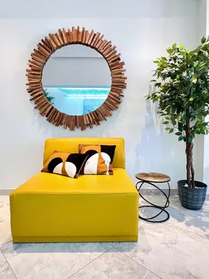 a yellow couch in a living room with a mirror at Luxury Beach House - Casa do Farol by BeCherish in Albufeira