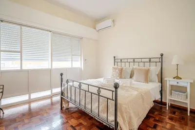 a bedroom with a bed and a wooden floor at BeGuest Dream House in Loulé