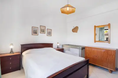 a bedroom with a large bed and a mirror at Sol Nascente 2_vilamoura in Quarteira