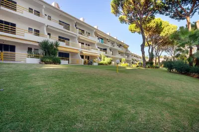 a large building with a large yard in front of it at Sol Nascente 2_vilamoura in Quarteira