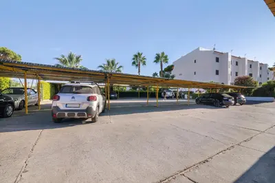 a car parked in a parking lot with a canopy at Sol Nascente 2_vilamoura in Quarteira
