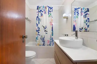 a bathroom with a sink and a toilet and a tub at Sol Nascente 2_vilamoura in Quarteira