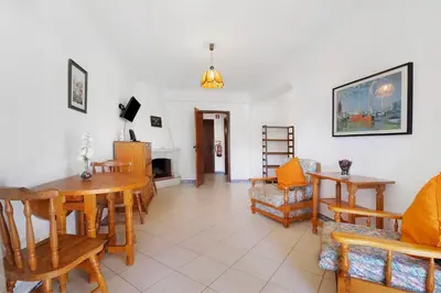 a living room with a dining room table and chairs at Sol Nascente 2_vilamoura in Quarteira