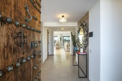 a hallway with a wooden wall with plates on it at Villa Avalon - Bedzy Luxury in Almancil