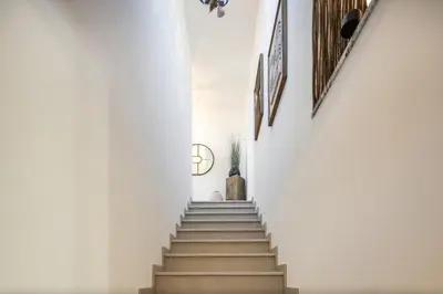 a staircase in a building with a person walking down it at Villa Avalon - Bedzy Luxury in Almancil