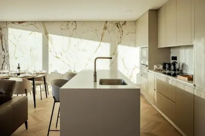 a kitchen with a sink and a table with chairs at The View at The Downtown Faro in Faro