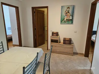 a dining room with a table and a picture on the wall at Blife Candya private apartment in Monte Negro