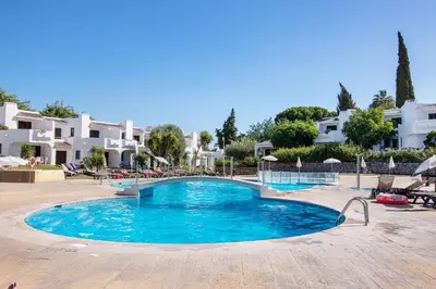 a swimming pool in the middle of a resort at Kyara House in Albufeira