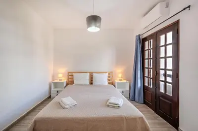 a bedroom with a bed with two towels on it at A Casa da Ana - By Algarkasa in Albufeira