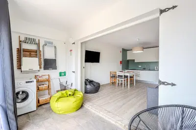 a kitchen and living room with a washer and dryer at A Casa da Ana - By Algarkasa in Albufeira