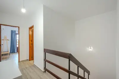 a staircase in a room with white walls at A Casa da Ana - By Algarkasa in Albufeira
