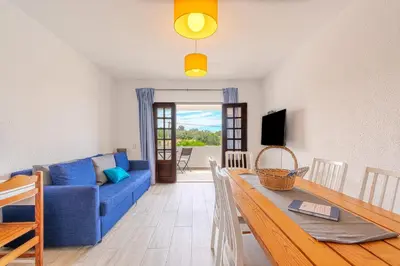 a living room with a blue couch and a table at A Casa da Ana - By Algarkasa in Albufeira