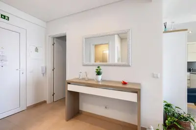 a bathroom with a sink and a mirror on a wall at Paraná in Quarteira