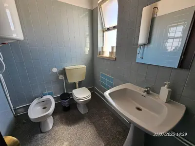 a bathroom with a toilet and a sink and a urinal at Blife Osonya - private rooms at Santantonya 4th floor in Faro
