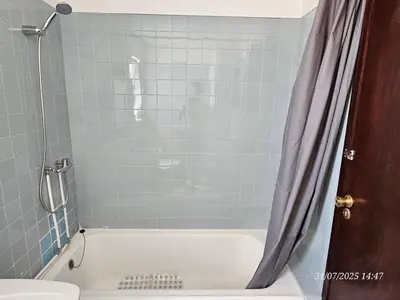 a bathroom with a shower with a white tub at Blife Osonya - private rooms at Santantonya 4th floor in Faro