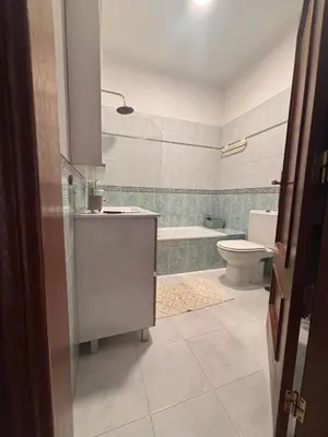 a bathroom with a tub and a toilet and a sink at NEW! Casa do Praia Almancil in Almancil