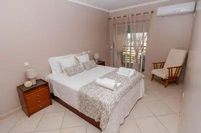 a bedroom with a bed with two towels on it at Ver o Mar in Albufeira