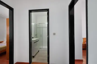 a bedroom with a bed and a dresser and a mirror at Casa Mar Sol E Sossego in Albufeira