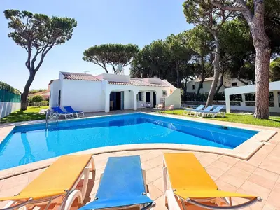 a swimming pool with chairs and a house at Vista Golf by Becherish in Bicas