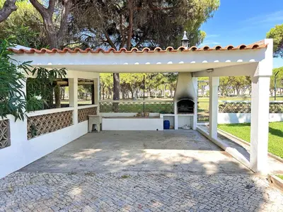 a white pergola with a fireplace in a yard at Vista Golf by Becherish in Bicas