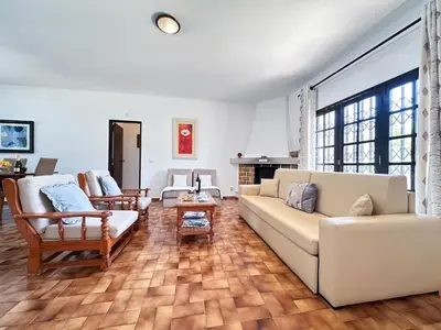 a living room with a couch and a table at Vista Golf by Becherish in Bicas