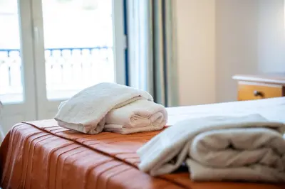 a bed with two towels on top of it at Central 2 Beedroms Old Tow Apartment in Albufeira