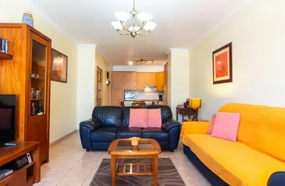 a living room with a couch and a table at Central 2 Beedroms Old Tow Apartment in Albufeira