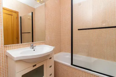 a bathroom with a sink and a mirror and a tub at Central 2 Beedroms Old Tow Apartment in Albufeira