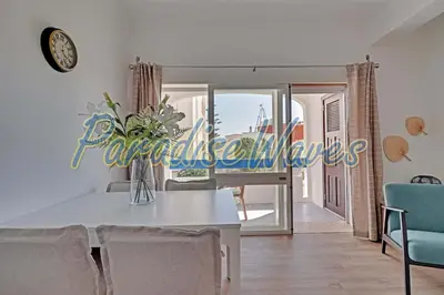 a dining room with a white table and chairs at Apartment Ouramar - 550 meters from de beach in Albufeira