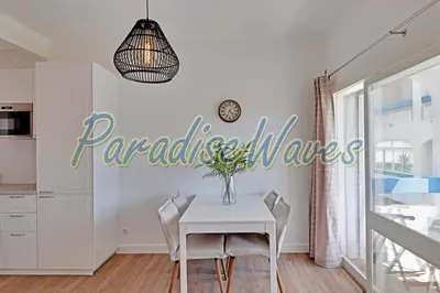 a dining room with a table and a sign on the wall at Apartment Ouramar - 550 meters from de beach in Albufeira