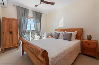 a bedroom with a large bed with two towels on it at BnB Homes Eco Apartment with Terrace, 2 Swimming pools & Tennis court in Albufeira