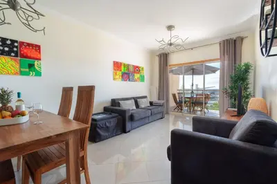 a living room with a couch and a table at BnB Homes Eco Apartment with Terrace, 2 Swimming pools & Tennis court in Albufeira