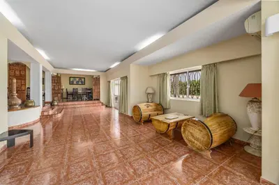 an empty living room with a table and chairs at Villa Saromani in Branqueira