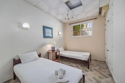a room with two beds and a window at Villa Saromani in Branqueira
