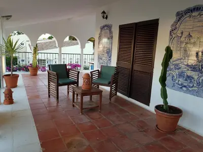 a patio with chairs and a table and plants at Vila Candeias, Vilamoura, Algarve, Beach, 10p in Quarteira