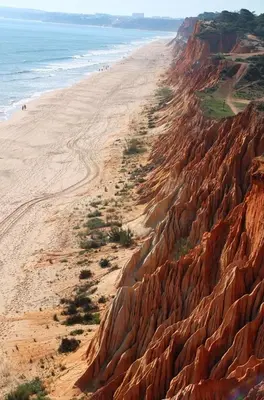 a sandy beach with people walking on it next to the ocean at Vila Candeias, Vilamoura, Algarve, Beach, 10p in Quarteira
