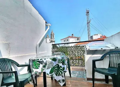 a table and two chairs on a balcony with a view at Casa do Pino in Faro