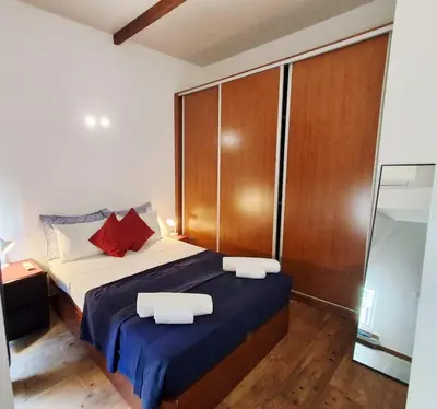a bedroom with a bed with two towels on it at Casa do Pino in Faro