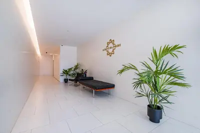 a waiting room with a bench and potted plants at Prime Luxury Apartment by Atlantic Places in Albufeira