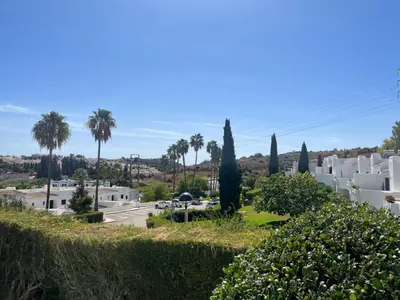 a bedroom with a bed with blue and white sheets at MyInzu - Club Albufeira Village Garden in Albufeira