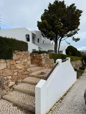 a table and chairs with wine glasses on it at MyInzu - Club Albufeira Village Garden in Albufeira