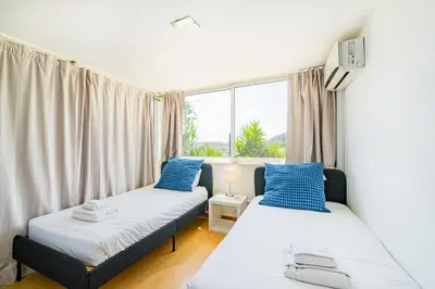two beds in a room with a window at Villa Okapi by Atlantic Places in Albufeira