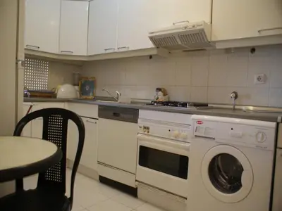 a kitchen with a washing machine and a sink at Akisol Vilamoura Rise in Quarteira
