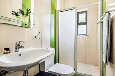 a bathroom with a sink and a toilet at Villa Lela in Galé