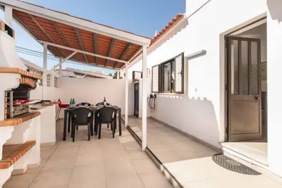 a patio with a table and chairs in a house at Villa Lela in Galé