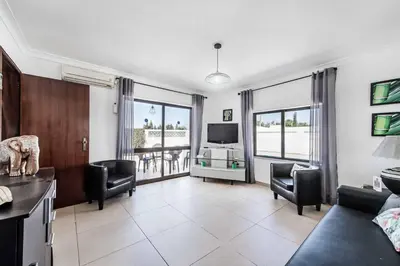 a living room with a couch and chairs and a television at Villa Lela in Galé