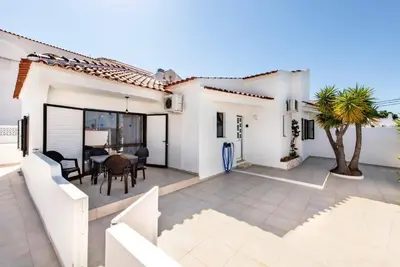 a white house with a patio with a table at Villa Lela in Galé