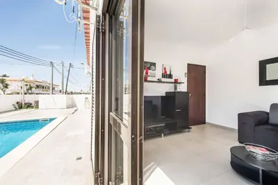 a living room with a tv and a swimming pool at Villa Dela in Galé